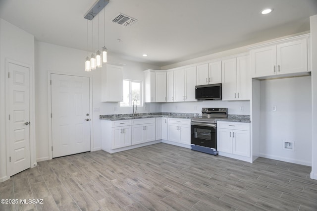 kitchen featuring light hardwood / wood-style floors, sink, appliances with stainless steel finishes, white cabinets, and pendant lighting