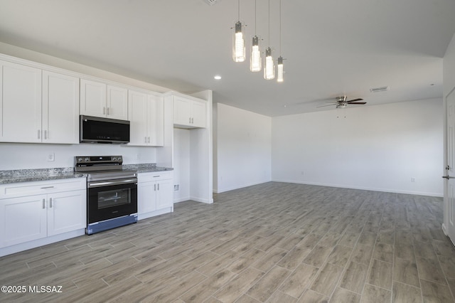 kitchen featuring white cabinetry, stainless steel range with electric stovetop, hanging light fixtures, and light hardwood / wood-style floors