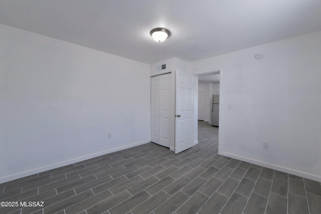 spare room with visible vents and baseboards