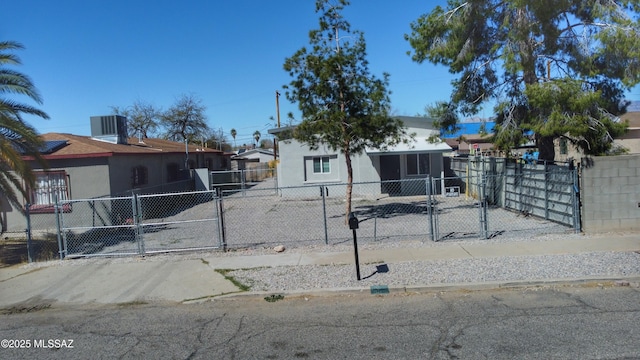 view of front of property featuring a fenced front yard, central AC unit, and a gate