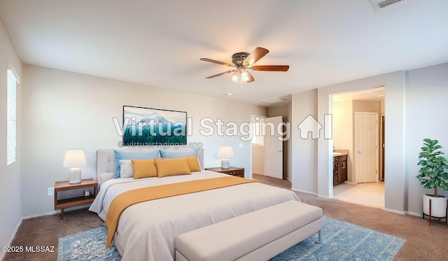 bedroom with ensuite bathroom, ceiling fan, and light colored carpet