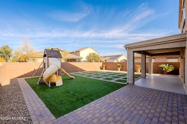 view of yard featuring a patio and a playground