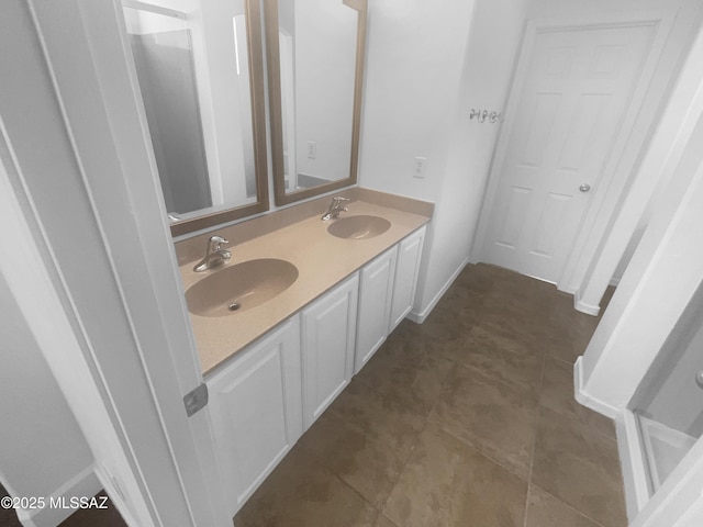 bathroom featuring a sink, baseboards, and double vanity