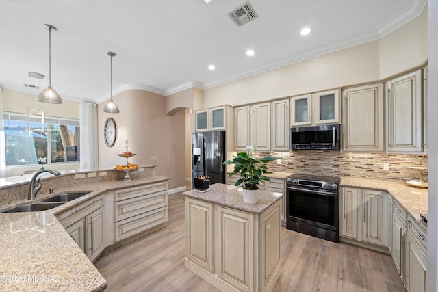 kitchen featuring a sink, stainless steel electric range oven, cream cabinets, fridge with ice dispenser, and visible vents