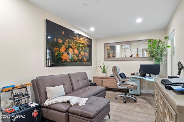 office featuring a wall mounted air conditioner, wood finished floors, and recessed lighting