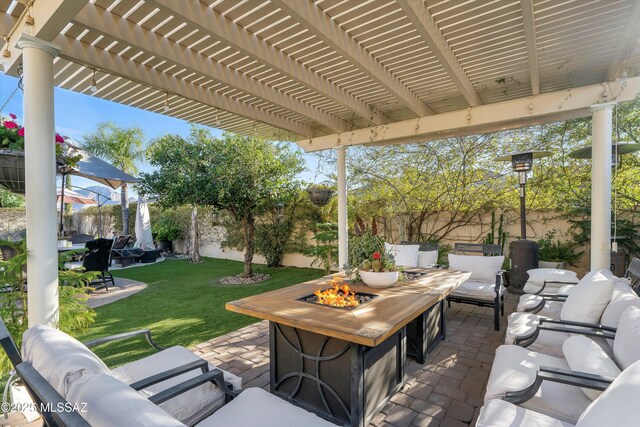 view of patio featuring a pergola, a fenced backyard, and an outdoor living space with a fire pit