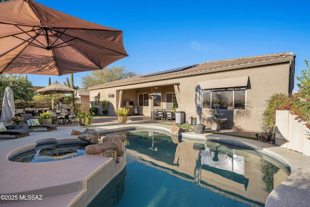 view of swimming pool with outdoor dining area, a patio, and an in ground hot tub