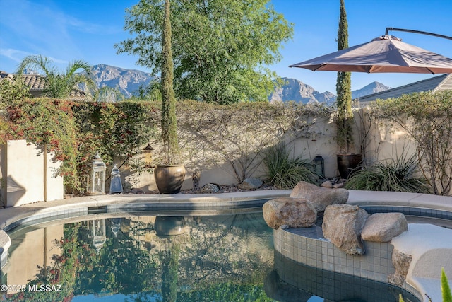 view of pool with a mountain view, a fenced in pool, and a fenced backyard