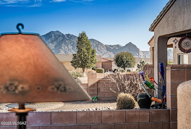 view of yard featuring fence and a mountain view