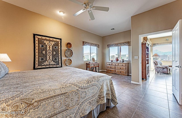 tiled bedroom featuring a ceiling fan, visible vents, and baseboards