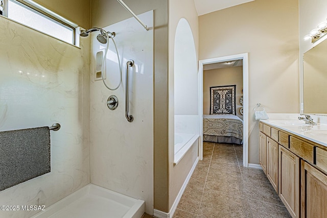 bathroom featuring a washtub, connected bathroom, vanity, tile patterned flooring, and baseboards