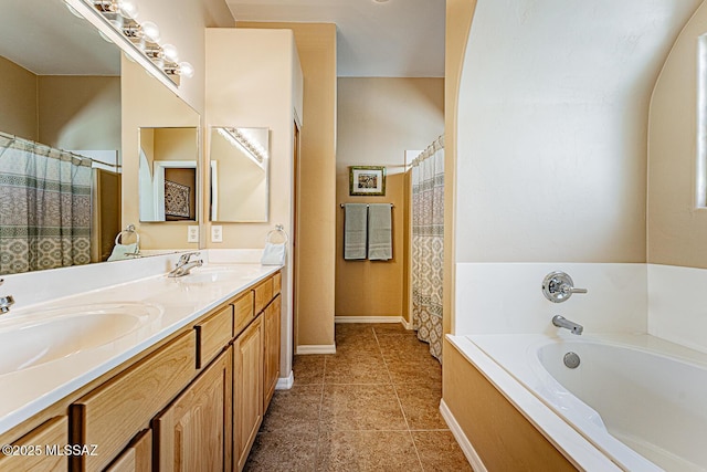 bathroom featuring a garden tub, double vanity, tile patterned flooring, and a sink