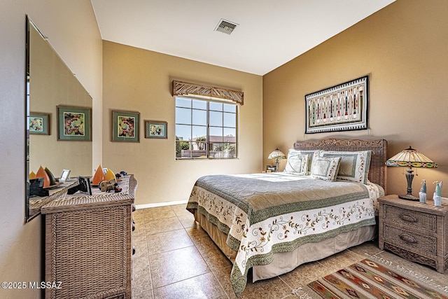 bedroom with light tile patterned floors, visible vents, and baseboards