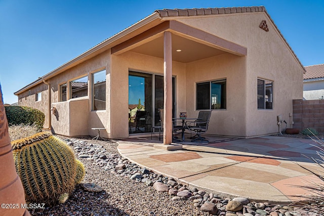 back of property featuring a patio, fence, and stucco siding