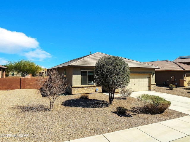 single story home with stucco siding, driveway, fence, an attached garage, and brick siding