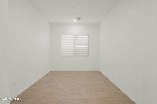 unfurnished room with visible vents and baseboards