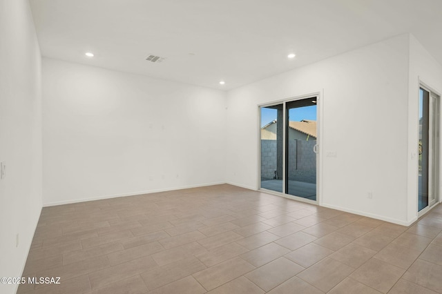 spare room with baseboards, visible vents, and recessed lighting