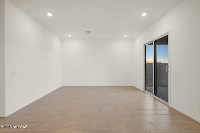 empty room with baseboards, visible vents, and recessed lighting