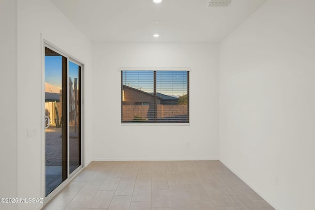 spare room featuring recessed lighting, visible vents, and baseboards