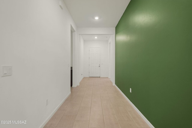 hall featuring baseboards and recessed lighting