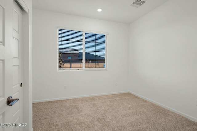 empty room featuring carpet, visible vents, baseboards, and recessed lighting