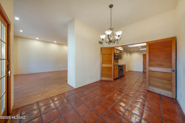 spare room featuring dark tile patterned floors, recessed lighting, visible vents, and a notable chandelier