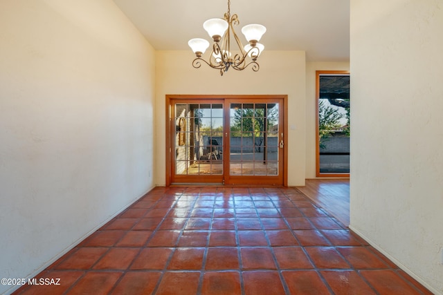 entryway with tile patterned flooring and a notable chandelier