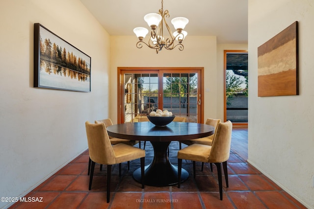 dining room featuring a notable chandelier and french doors