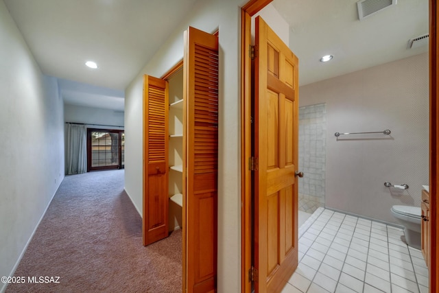 hall with light colored carpet, visible vents, recessed lighting, and light tile patterned floors