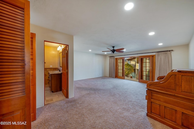 interior space featuring light carpet, access to outside, ensuite bathroom, and recessed lighting