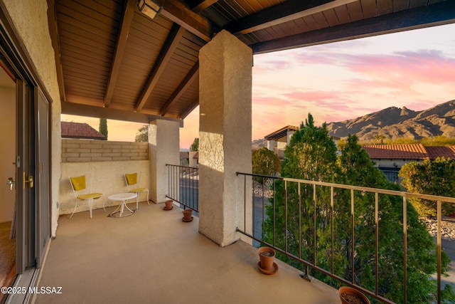 view of patio featuring a mountain view and a balcony