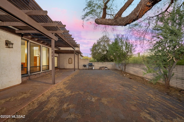 view of yard featuring a patio area, a fenced backyard, and a pergola