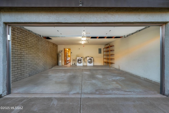 garage featuring washer and dryer and water heater