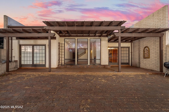 rear view of property featuring a patio area, brick siding, and a pergola