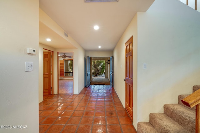 corridor featuring tile patterned flooring, visible vents, recessed lighting, and stairs