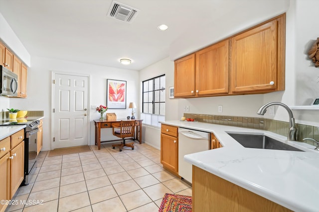 kitchen with sink, dishwasher, electric range, and light tile patterned floors