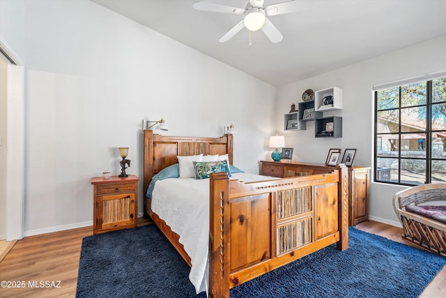 bedroom with hardwood / wood-style flooring, ceiling fan, and lofted ceiling