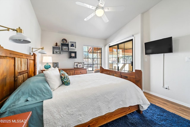 bedroom featuring hardwood / wood-style flooring, ceiling fan, and vaulted ceiling