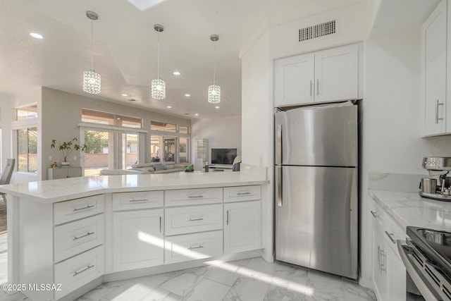 kitchen featuring stainless steel appliances, white cabinets, and visible vents