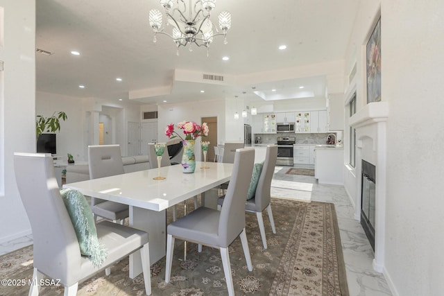 dining room with recessed lighting, marble finish floor, visible vents, and an inviting chandelier