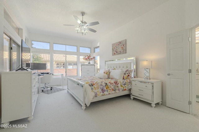 bedroom featuring light carpet and a ceiling fan