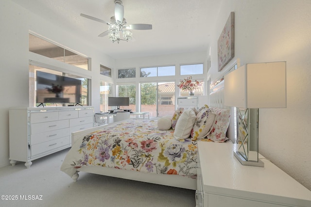 bedroom with light carpet and a ceiling fan