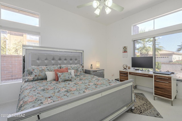 bedroom featuring multiple windows and a ceiling fan