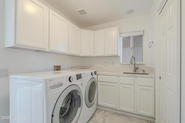 laundry area featuring marble finish floor, washing machine and clothes dryer, cabinet space, visible vents, and a sink