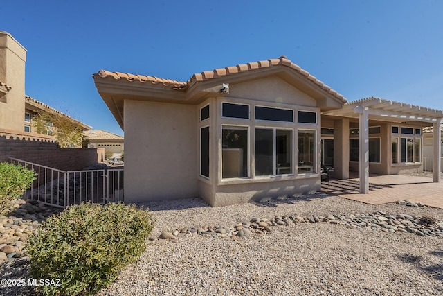 rear view of property with a patio area, fence, a pergola, and stucco siding