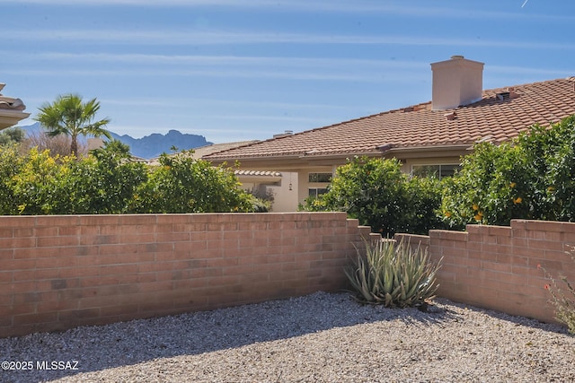 view of yard with a mountain view and fence