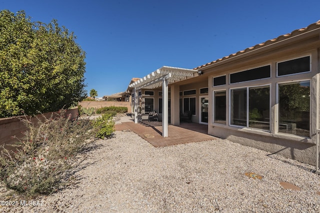 back of property with a patio, a fenced backyard, and a pergola