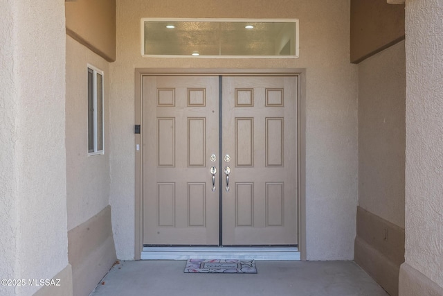 property entrance featuring stucco siding