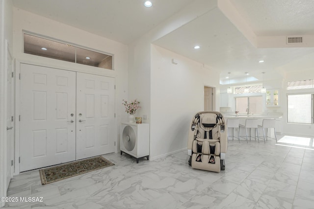 entryway featuring baseboards, marble finish floor, visible vents, and recessed lighting