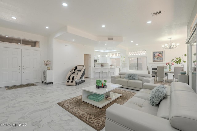 living area with recessed lighting, marble finish floor, and visible vents